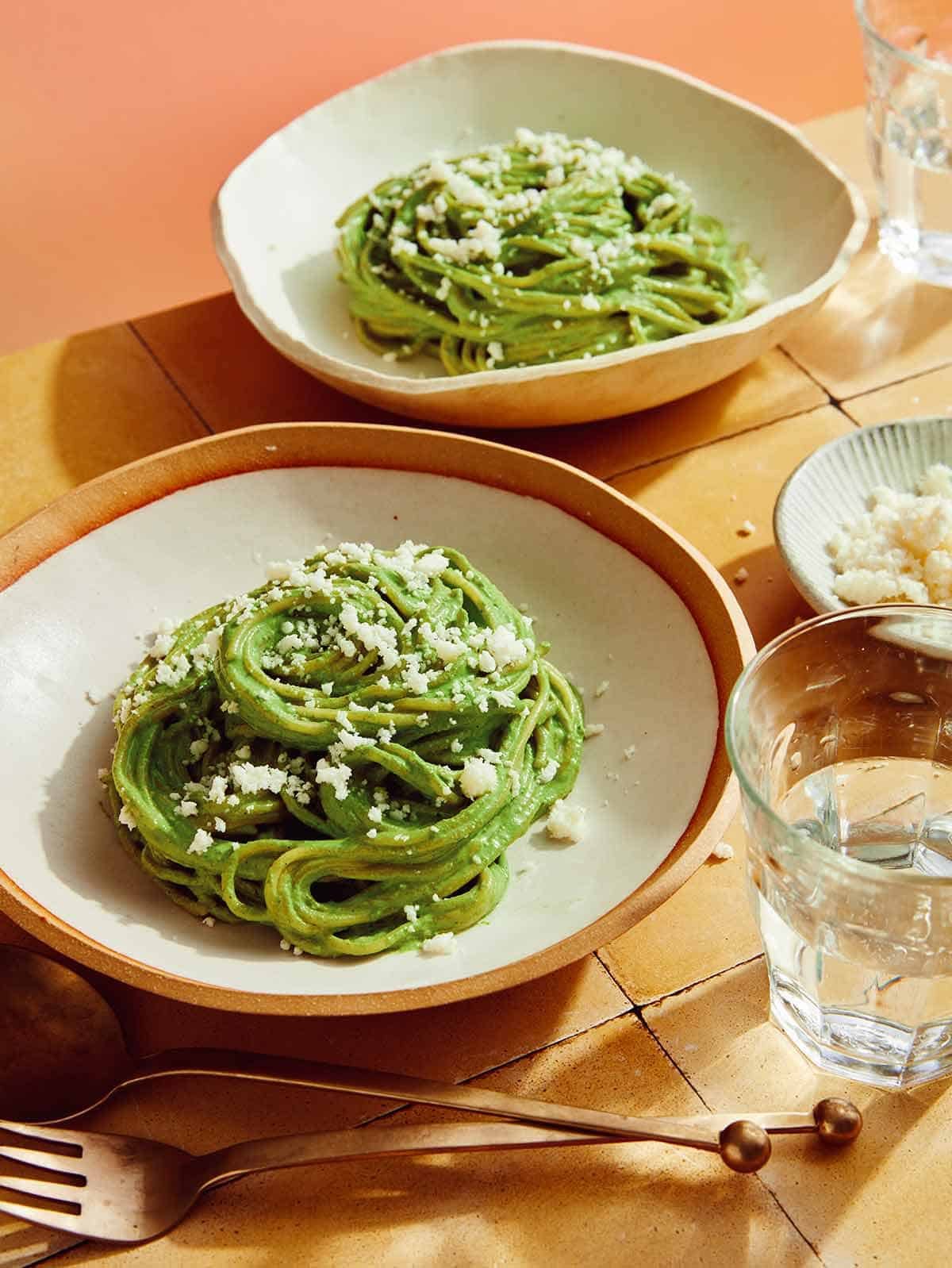 Tallarines Verde pasta dish in two bowls ready to be served.