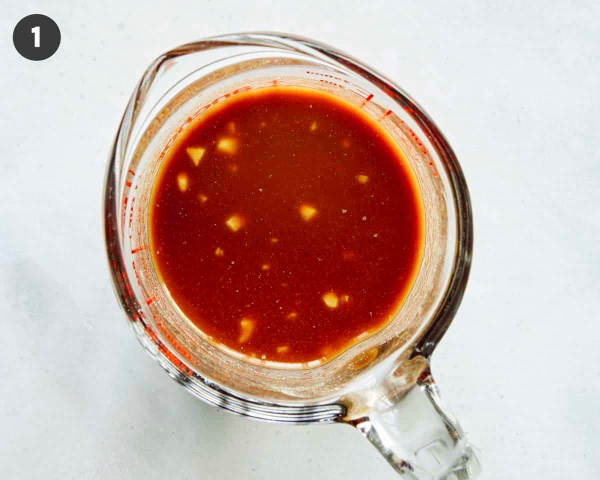 Cashew chicken sauce in a glass bowl mixed together.