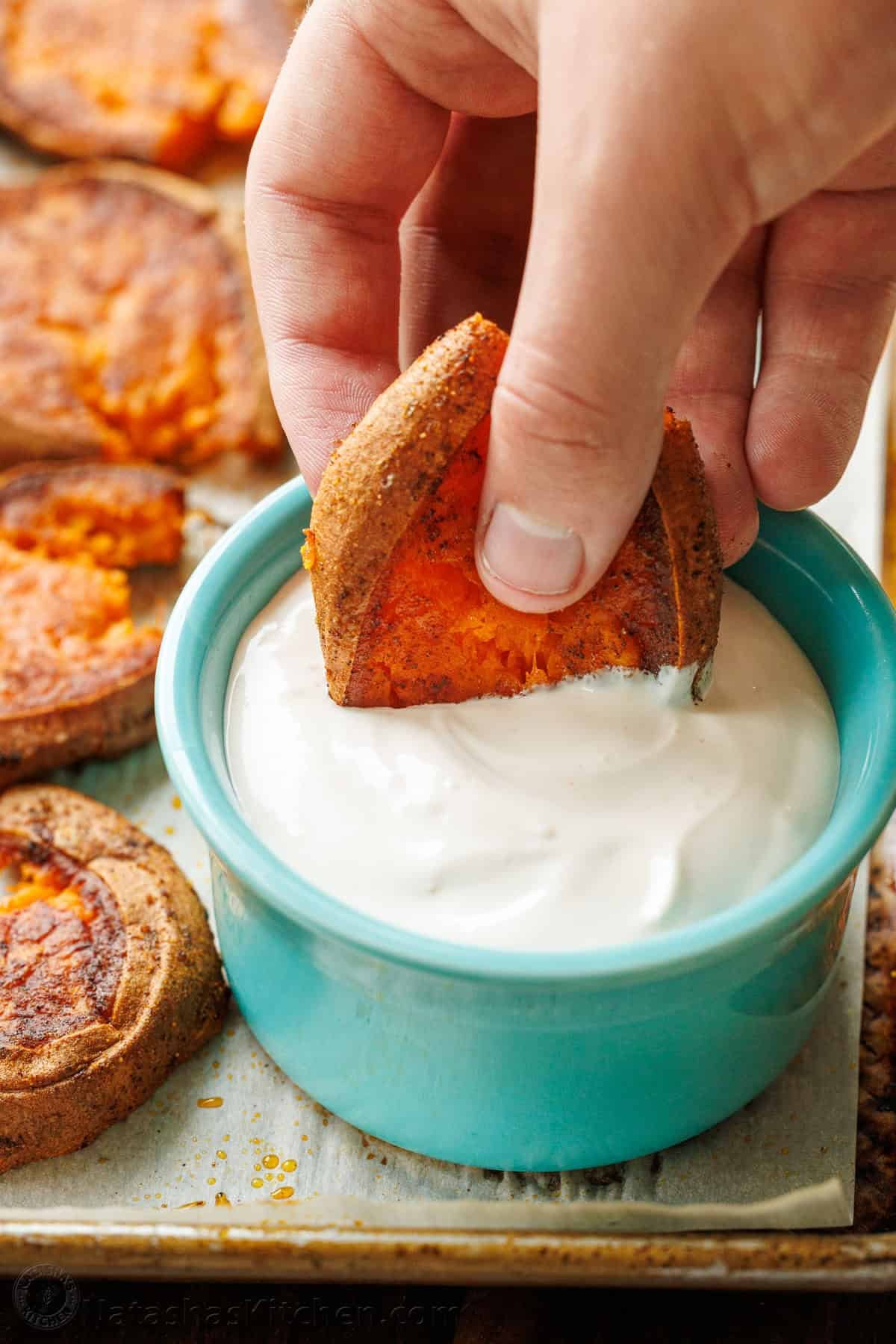 Smashed Sweet potato dipped into lemon garlic dipping sauce