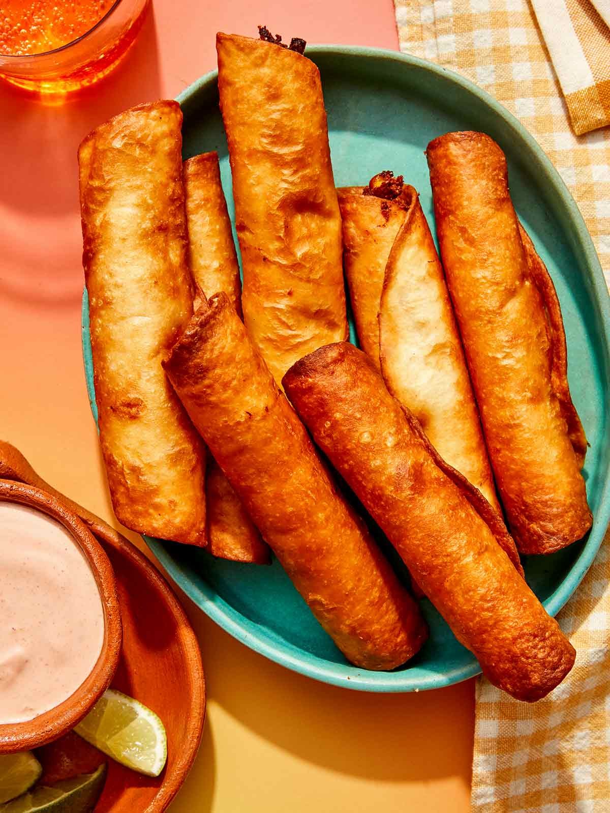Close up on a bowl of freshly made flautas.