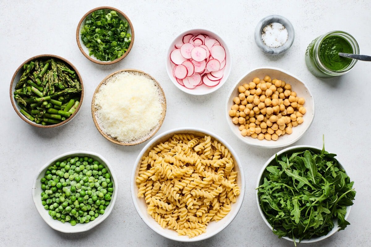 ingredients in bowls to make Pasta Salad with Asparagus, Chickpeas & Basil Vinaigrette. 