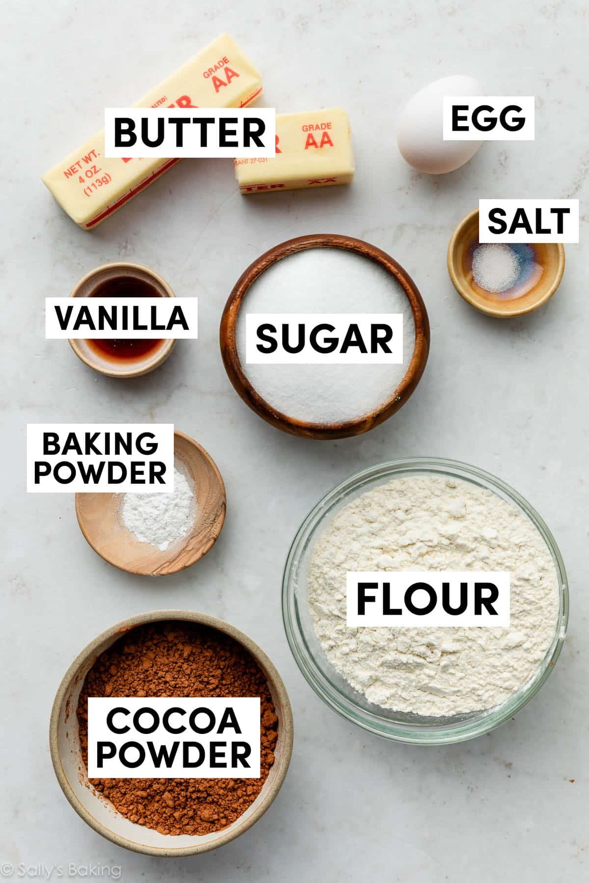 ingredients measured in bowls including flour, cocoa powder, and sugar.