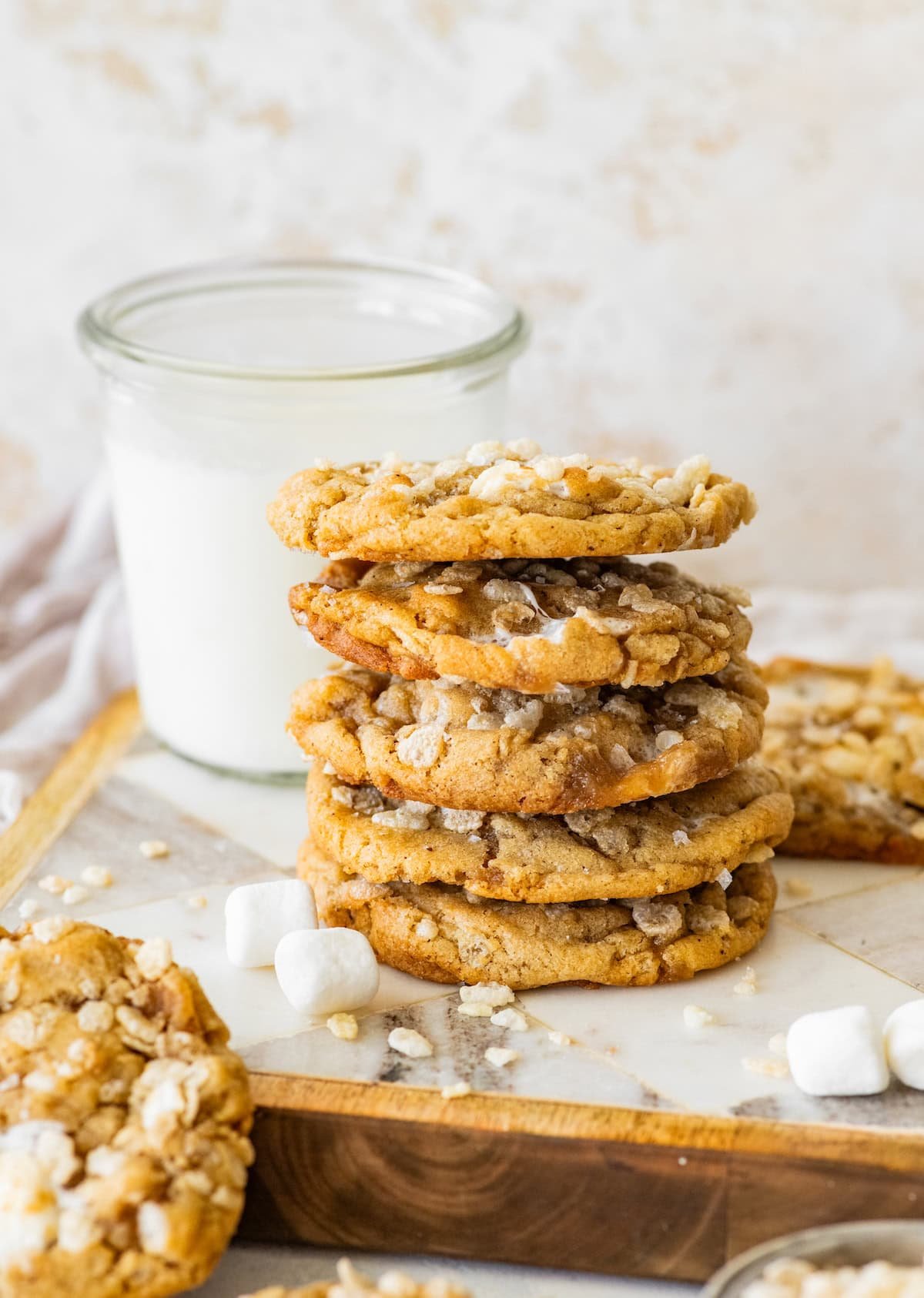 stack of rice krispie treat cookies with glass of milk. 
