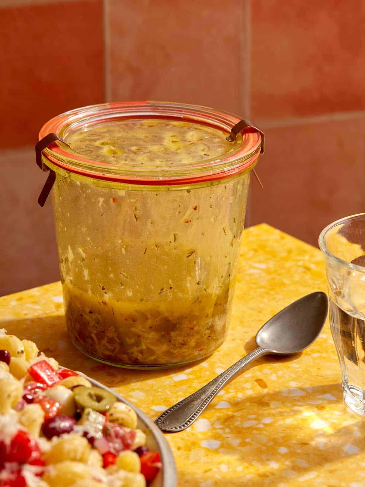 Italian vinaigrette recipe on a table in a jar. 