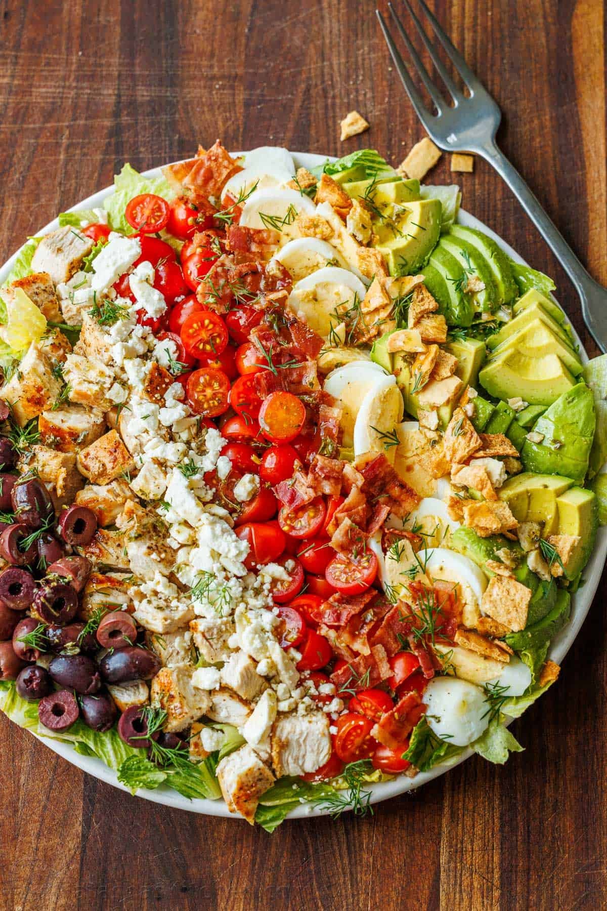 Colorful Greek Cobb Salad on a plate with a fork