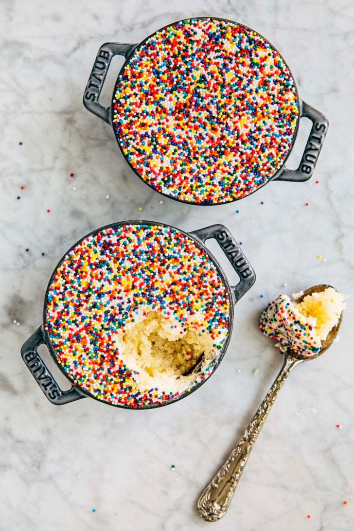 photo of two dot cakes in mini cast iron pans with a bite taken out of one
