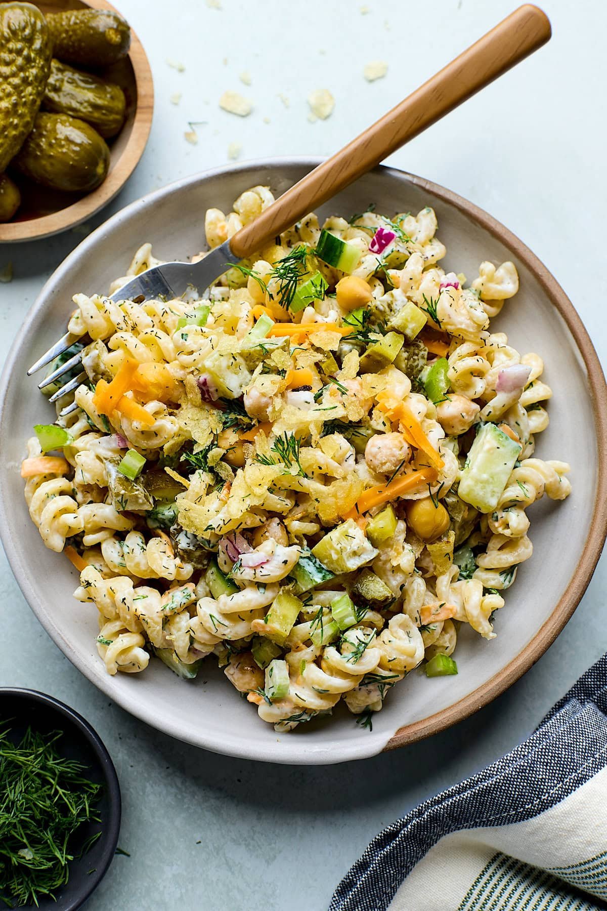 dill pickle pasta salad on plate with fork. 