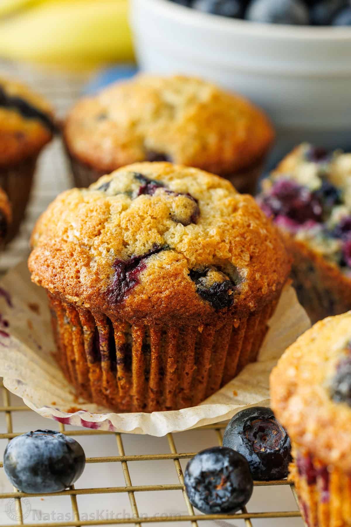 cupcake liner removed from cupcake with fresh berries and browned exterior
