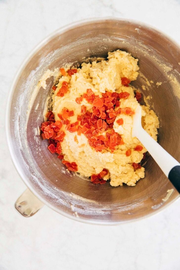 photo showing michelle mixing in the diced strawberry pieces into strawberry doodle cookie dough