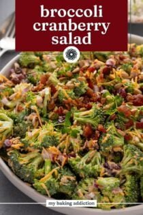 Close up of broccoli cranberry salad in a large serving bowl. Text overlay includes recipe name.