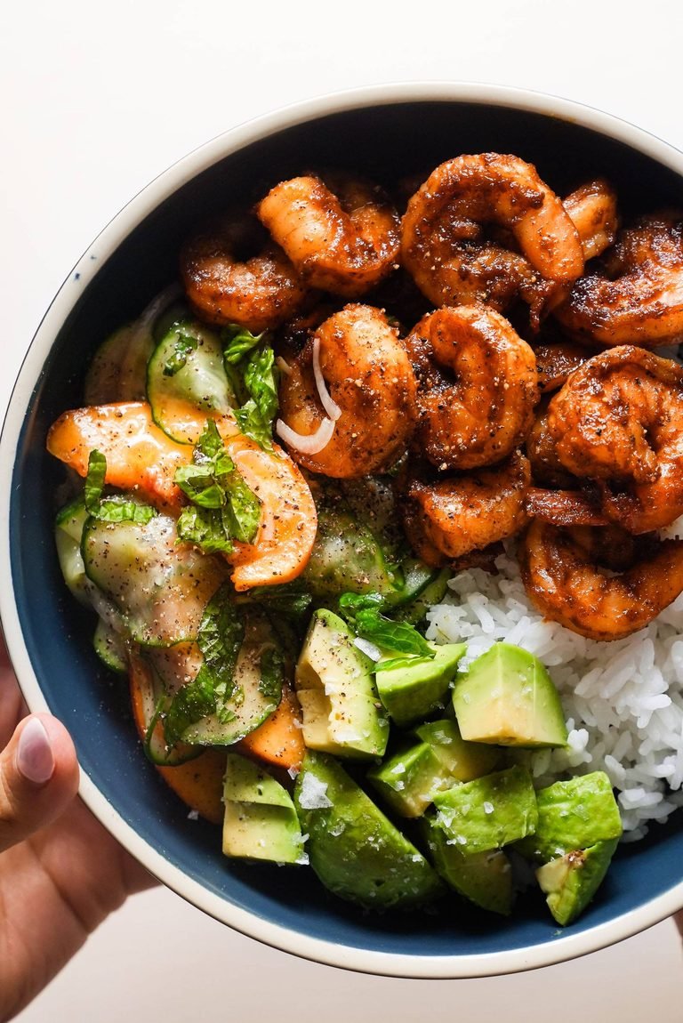 Spicy shrimp in a bowl with rice and peach salad.