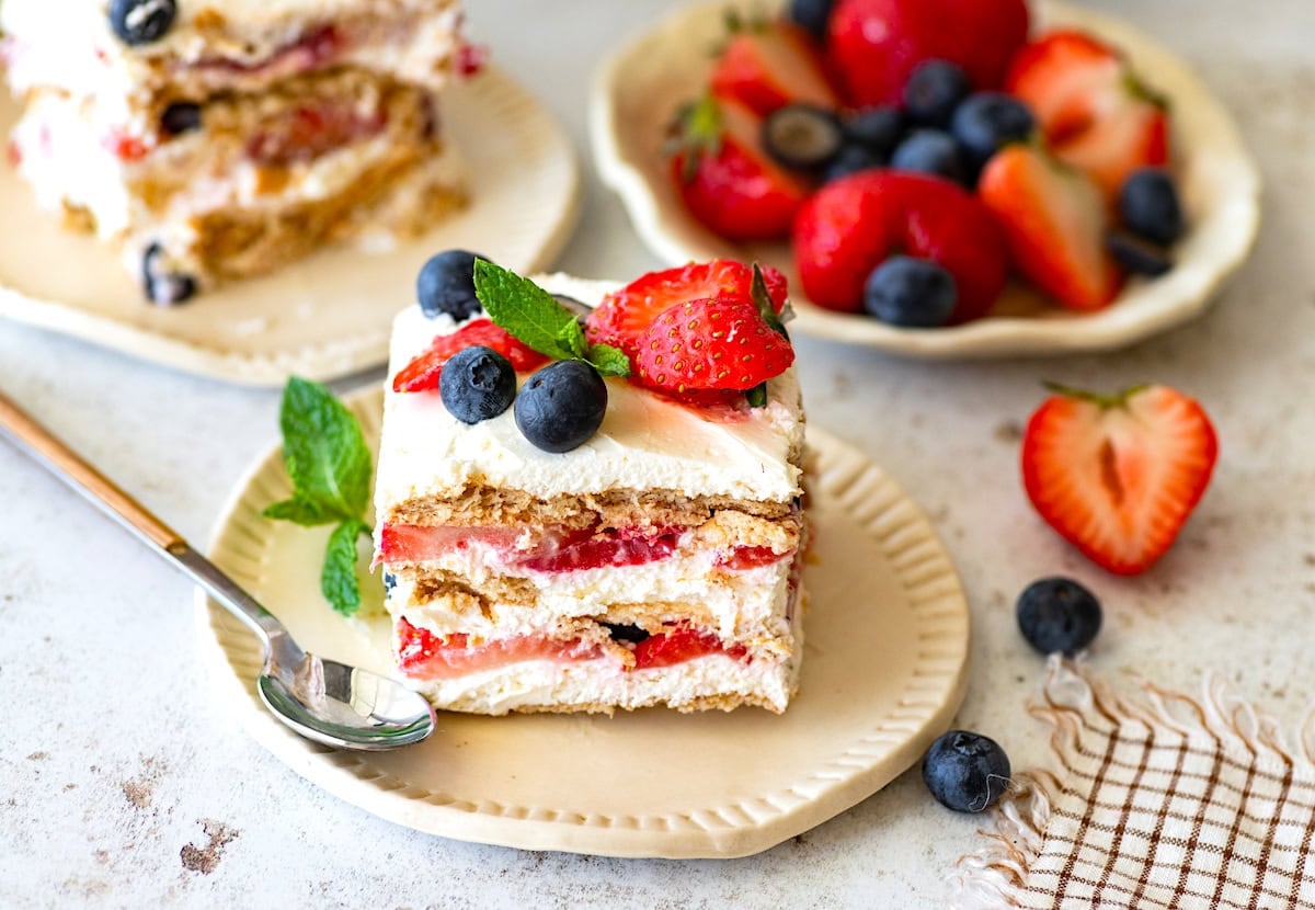 berry icebox cake on plate with spoon. 