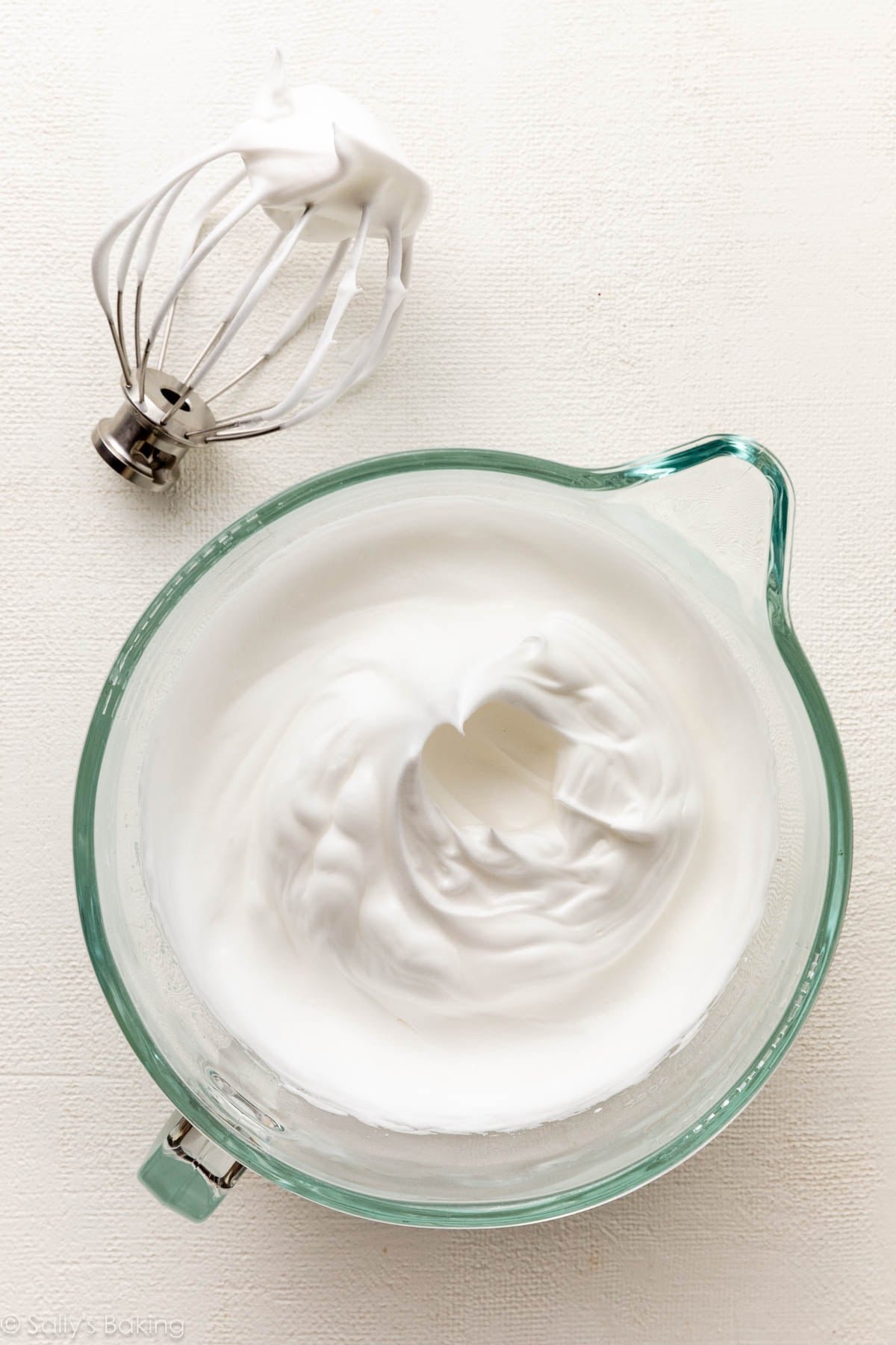 whipped egg whites in glass bowl.
