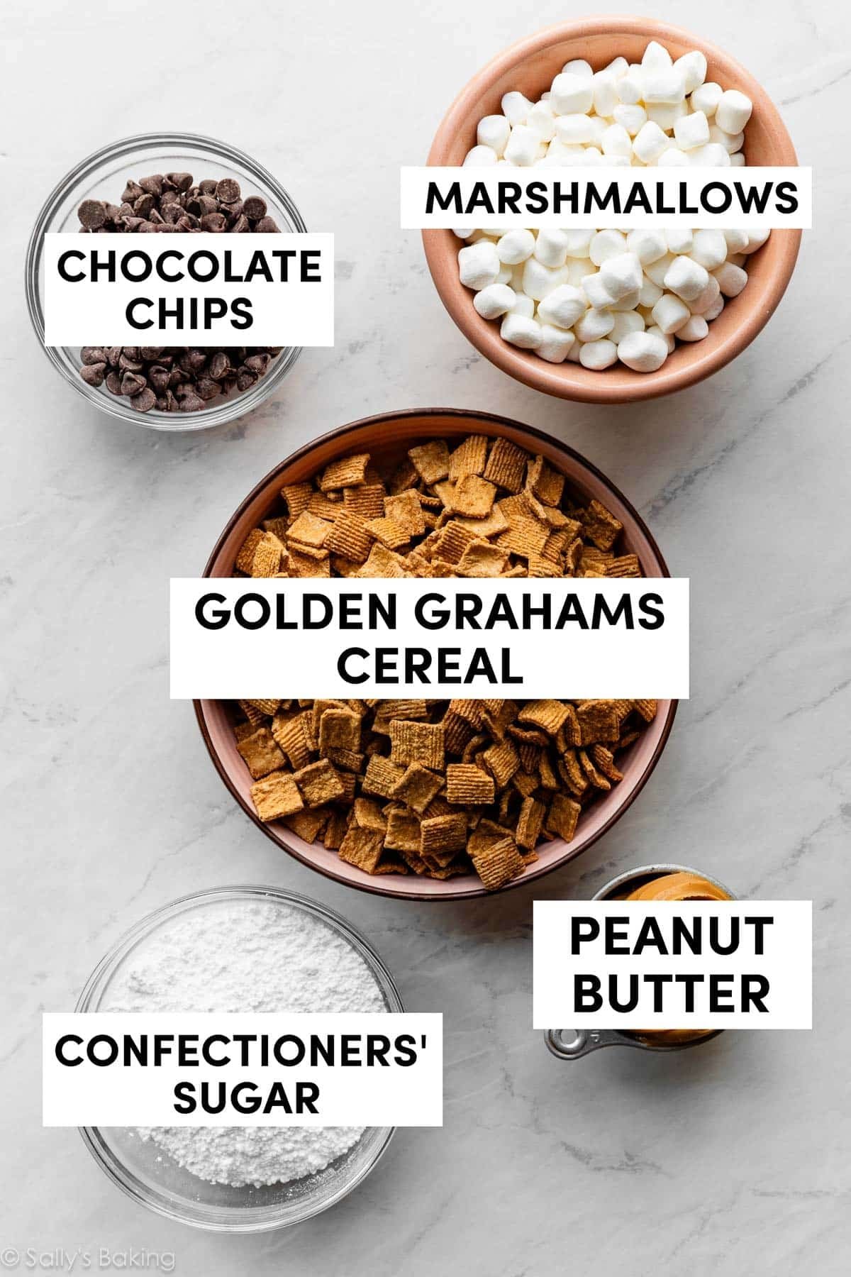 bowls of ingredients including golden grahams cereal, chocolate chips, and marshmallows.
