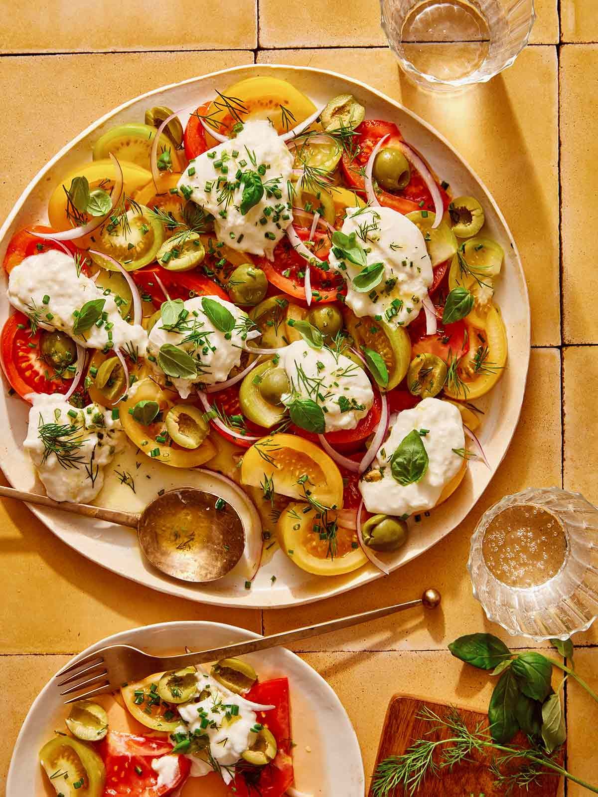 Tomato salad on a plate with some served.