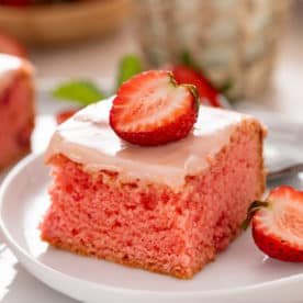 Sliced strawberry brownie on a white plate.