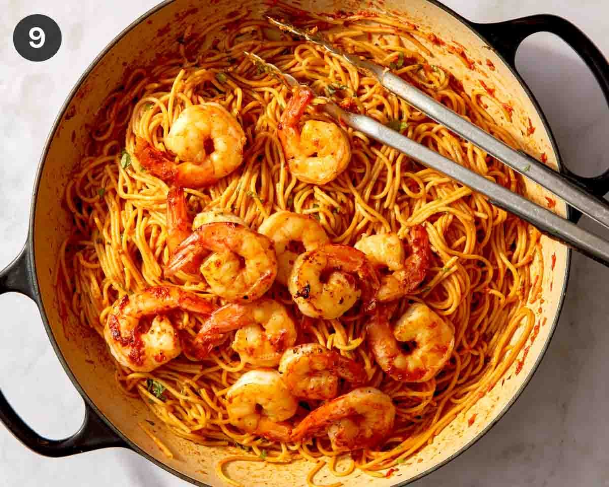 Tomato sauce pasta with shrimp in a skillet.