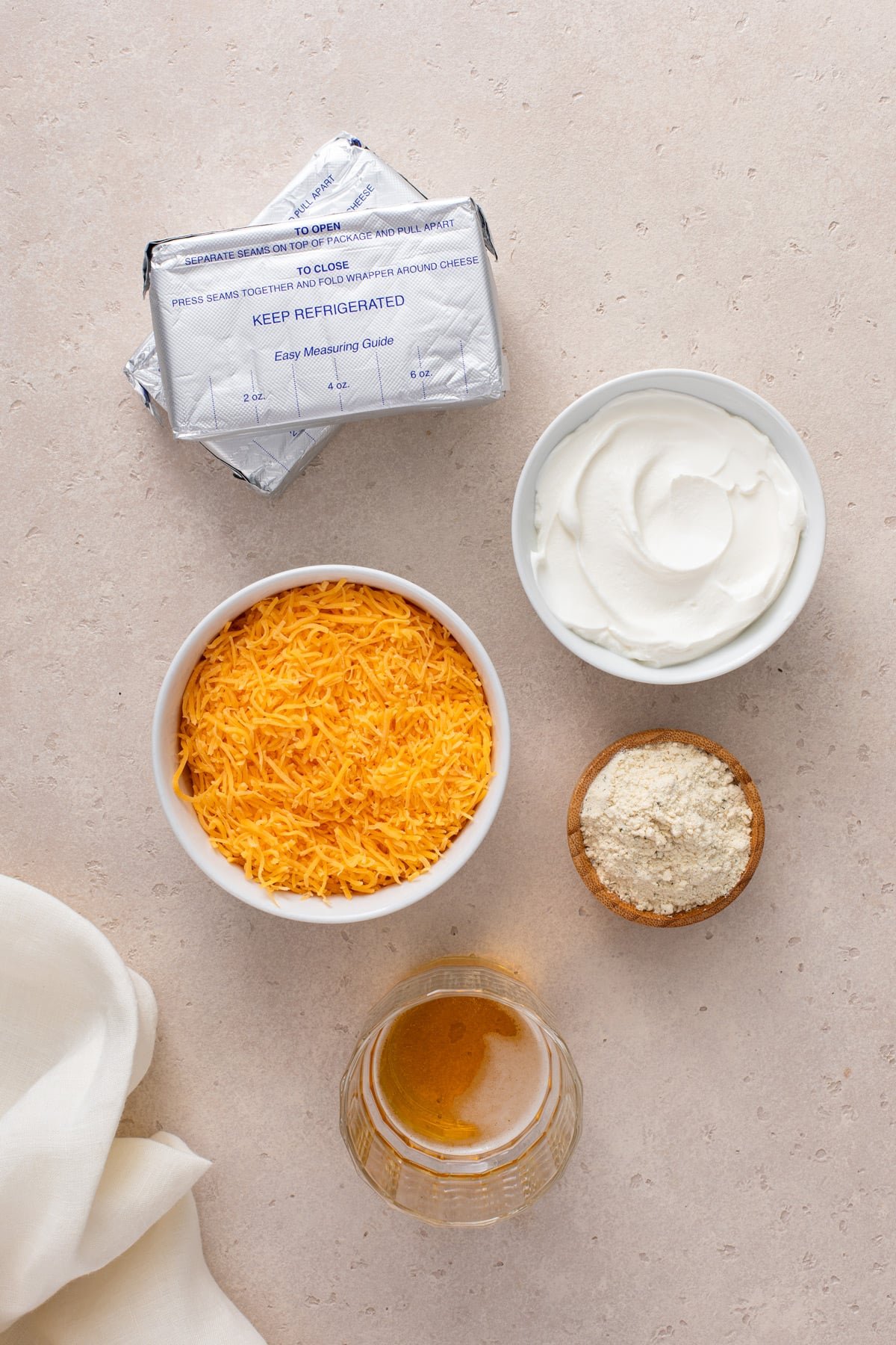 Ingredients for ranch beer cheese dip arranged on a countertop.