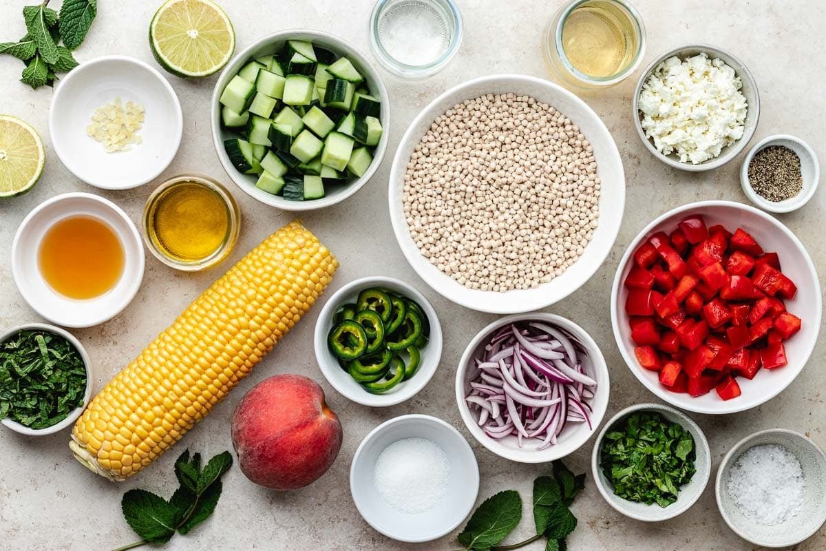 ingredients in bowls to make summer couscous salad.