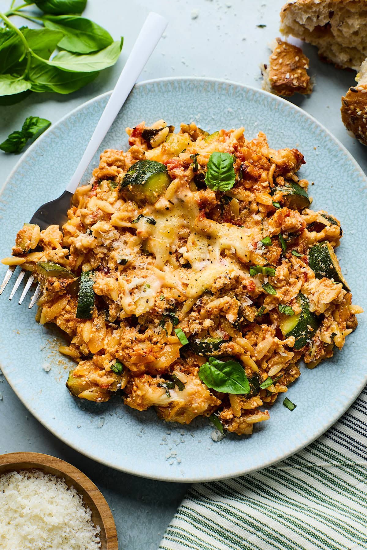 zucchini casserole on plate with fork.