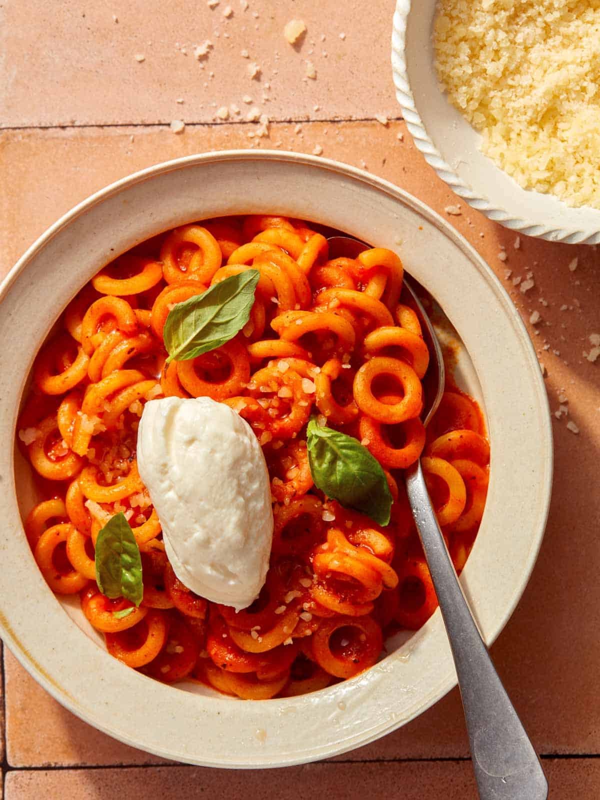 Spaghetti Ohs with ricotta on top and basil.