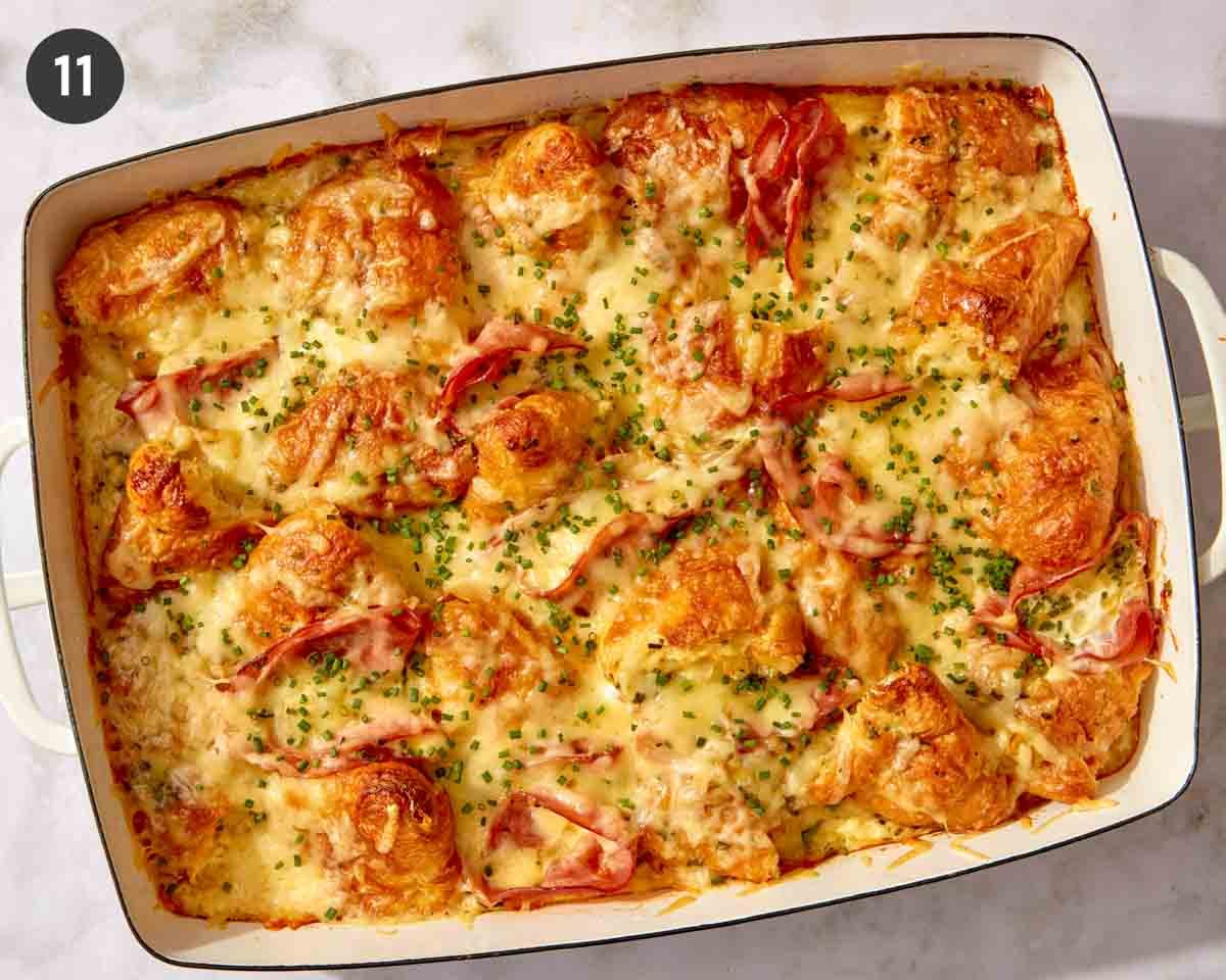 A finished ham and cheese croissant bake with chives on top.