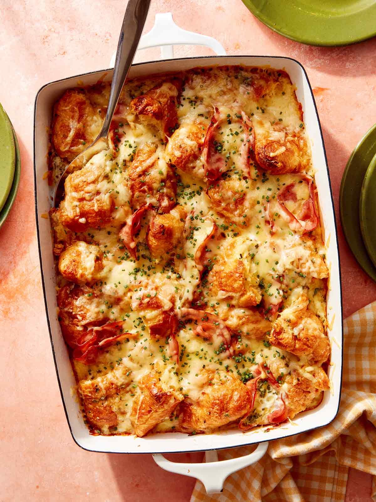 A casserole dish filled with ham and cheese croissant bake.