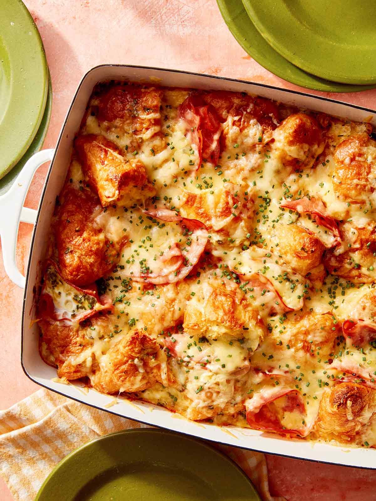 Croissant bake out of the oven ready to be served with plates on the side.
