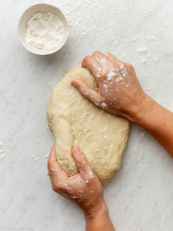 hands kneading dough.