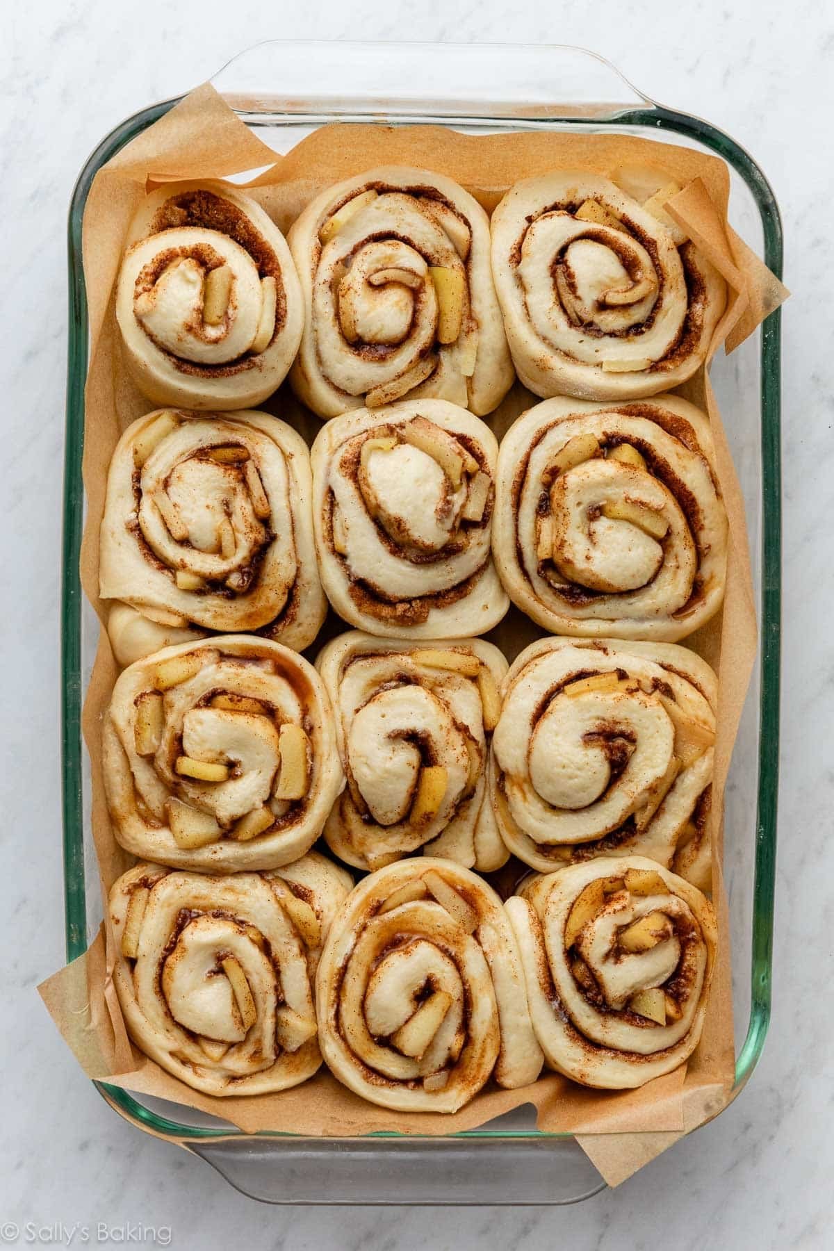 apple cinnamon rolls rising in pan.