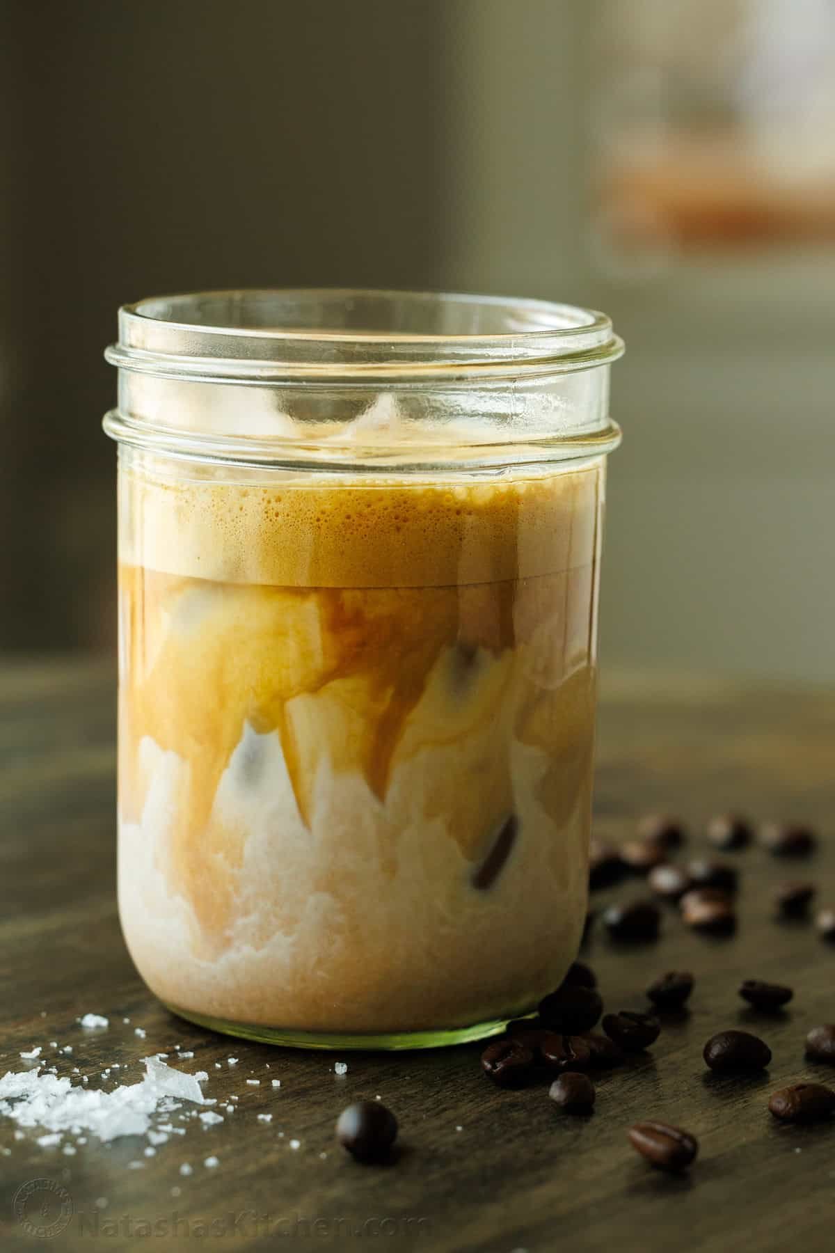 Salty Canadian Salted Maple Iced Latte with espresso beans and salt on the table