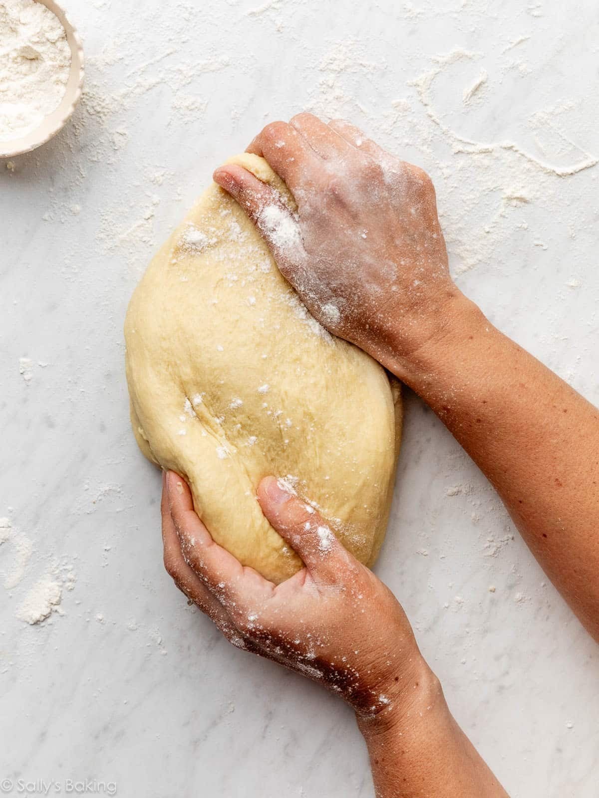 hands kneading dough.