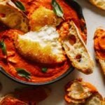 Fried burrata over romesco sauce with bread.