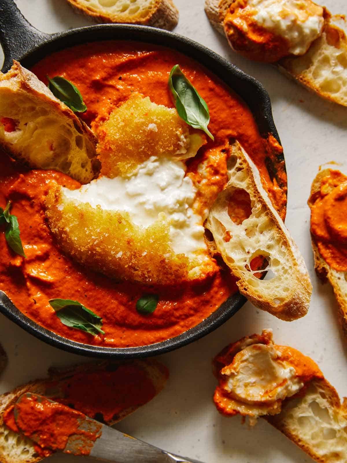 Fried burrata over romesco sauce with bread.