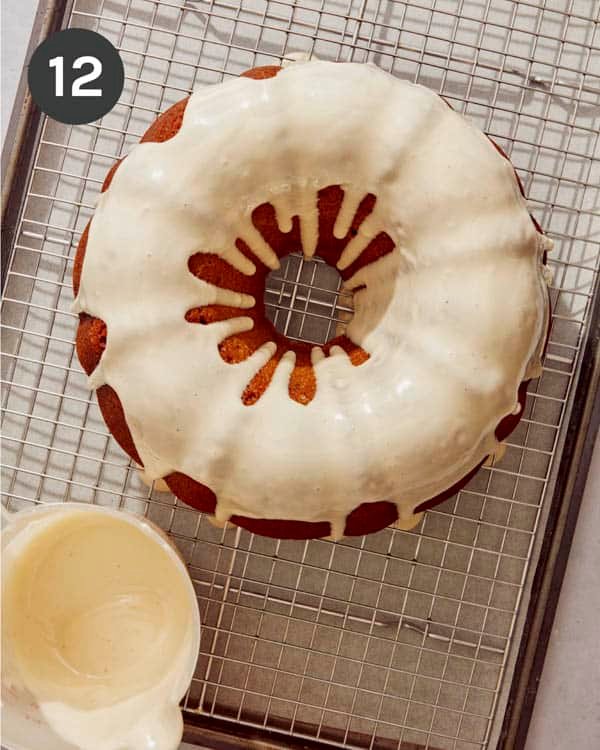 Pistachio glaze being poured onto a pumpkin cake.
