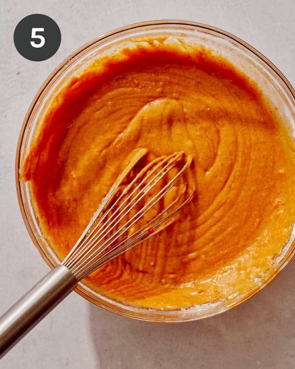 Pumpkin cake batter being mixed together.