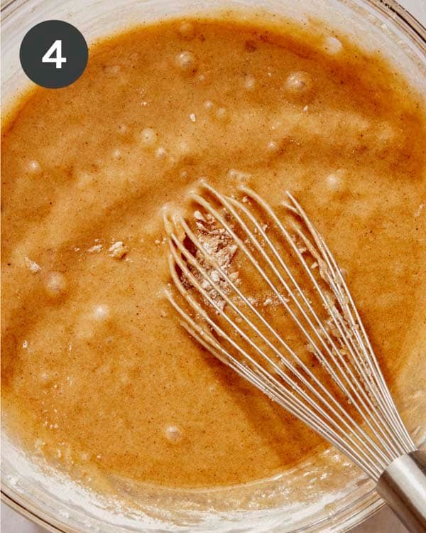 Pumpkin cake batter being mixed in a bowl.