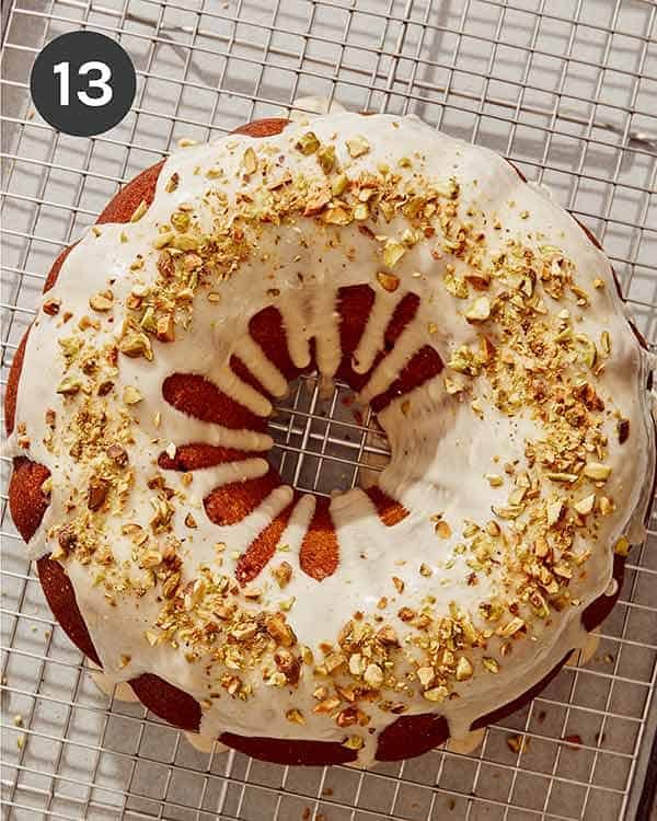 Pumpkin cake with glaze on top and crushed pistachios.